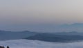 A sea of clouds and fog fills the valleys of the Apennine mountains at sunset Royalty Free Stock Photo