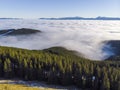 Sea of clouds and Picturesque Mountains Above. Beautiful Carpathians at early winter or Autumn Aerial View Royalty Free Stock Photo