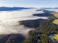 Sea of clouds and Picturesque Mountains Above. Beautiful Carpathians at early winter or Autumn Aerial View Royalty Free Stock Photo