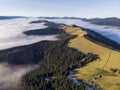 Sea of clouds and Picturesque Mountains Above. Beautiful Carpathians at early winter or Autumn Aerial View Royalty Free Stock Photo