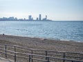 Sea coast against the backdrop of the city. Few people on the beach. Rocky shore of the Black Sea. Seaside holiday concept. Batumi Royalty Free Stock Photo