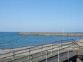 Sea coast against the backdrop of the city. Few people on the beach. Rocky shore of the Black Sea. Seaside holiday concept. Batumi Royalty Free Stock Photo