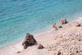 Sea coast and beach with rocks, rocky coastline, blue sea, good sunny day. Summer trip. Beautiful Greece. Most beautiful beach. Royalty Free Stock Photo