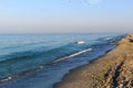 Sea coast and blue sky, beach, birds in the sky, ships on the horizon