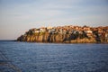 The sea coast of Bulgaria is a sandy beach with Golden sand and rocky high banks with tiled roofs of houses.