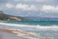 The sea coast of Bulgaria is a sandy beach with Golden sand and rocky high banks with tiled roofs of houses.