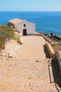 Sea coast and church. Porto-Torres, Italy Royalty Free Stock Photo