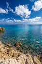 Sea coast with clear turquoise water and sharp stones on cape Cavo Greco, Cyprus. Vertical frame