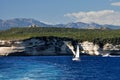 A sea coast in Corsica, Corse, France Europe with cliffs and sailing boat Royalty Free Stock Photo