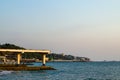 Sea coast with infrastructure: pier, breakwaters, moorings, buildings Royalty Free Stock Photo