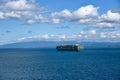 Large, green, cargo container ship owned by Evergreen Line, sailing out of port of Cristobal