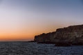 Sea coast and the rocks above the sea during sunset. Beautiful sea landscape Royalty Free Stock Photo