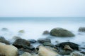 Sea coast with rocks and waves in motion blur. Royalty Free Stock Photo