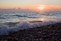 Sea coast with waves on sunset, Stony beach