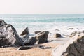 Sea crashing on rocky coast on sunny day Royalty Free Stock Photo