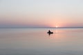 Sea at dawn with fishing rubber boat, calm.