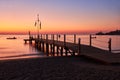 Sea dawn overlooking a large wooden pier and swimming pontoon Royalty Free Stock Photo