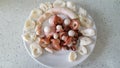 Sea delicacy. Octopus lying on a plate in pieces. Homemade food concept of seafood menu