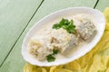 Sea fish stewed in milk-onion sauce