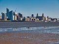 Sea fishing at low tide in the River Mersey with the panorama of the historic Liverpool waterfront in the background