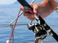 Sea fishing, spinning reel and fishing hook close-up