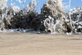 Sea foam created by waves surging on sand and creating amazing texture and patterns.