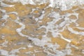 Sea foam over yellow sand beach