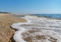 Sea foam on the shore from seashells and sand Royalty Free Stock Photo