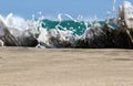 Sea foam created by waves surging on sand and creating amazing texture and patterns.