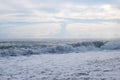 Sea foam waves, sunset on the sea, clouds over the waves in the sea, storm on the sea