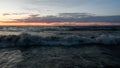 Sea foaming wave at sunset