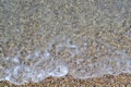 Sea foamy wave on a pebble beach top view Royalty Free Stock Photo