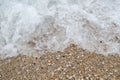 Sea foamy wave on a pebble beach top view Royalty Free Stock Photo