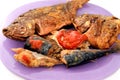 Sea food cuisine of various fishes, fried Nile tilapia fishes Oreochromis Niloticus fried in deep oil fryer with mackerel pelagic Royalty Free Stock Photo
