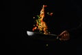 Sea food. A professional chef prepares assorted seafood and vegetables. Levitation. Food on a black background. Healthy vegetarian