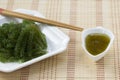 Sea grapes or green caviar and spicy sauce on a white dish the w Royalty Free Stock Photo