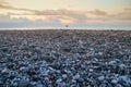 Sea gray pebbles on the seashore and yellow sunset Royalty Free Stock Photo