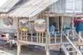 Sea gypsy house with birds in cages in Saladan