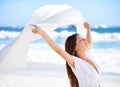 Sea, happy woman and fabric in wind at beach outdoor for summer, vacation and travel on holiday. Ocean, smile and person Royalty Free Stock Photo