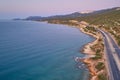 Sea, hills and asphalt motorway in the morning. Aerial view