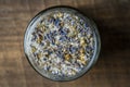 Sea himalayan salt with dry lavender and chamomile flowers in a glass jar on wooden background, closeup, top view Royalty Free Stock Photo