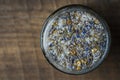 Sea himalayan salt with dry lavender and chamomile flowers in a glass jar on wooden background, closeup, top view Royalty Free Stock Photo