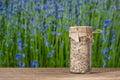 Sea himalayan salt with dry lavender and chamomile flowers in a glass jar on wooden table with the blue flowers background on a Royalty Free Stock Photo