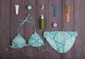 ÃÂ¤Sea holidays / travel concept - blue beautiful swimsuit and accessories: wooden hairbrush, sunscreen, bottles with cream, razor