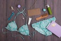 Sea holidays / travel concept - blue beautiful swimsuit, blank blackboard and accessories: wooden hairbrush, sunscreen, bottles Royalty Free Stock Photo