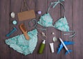 Sea holidays / travel concept - blue beautiful swimsuit, blank blackboard, airplane and accessories: wooden hairbrush, sunscreen, Royalty Free Stock Photo