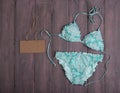 Sea holidays / travel concept - blue beautiful swimsuit in ornament and blank blackboard Royalty Free Stock Photo