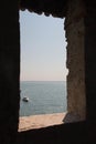 Sea and horizon line view from ancient medieval window Royalty Free Stock Photo