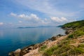 Sea horizon with rocky shore cliffs and sun light blue sky background. Sea waves crashing on rocks. Royalty Free Stock Photo