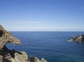 Sea horizon with sharp rocks and cliffs in forward, creal blue s Royalty Free Stock Photo